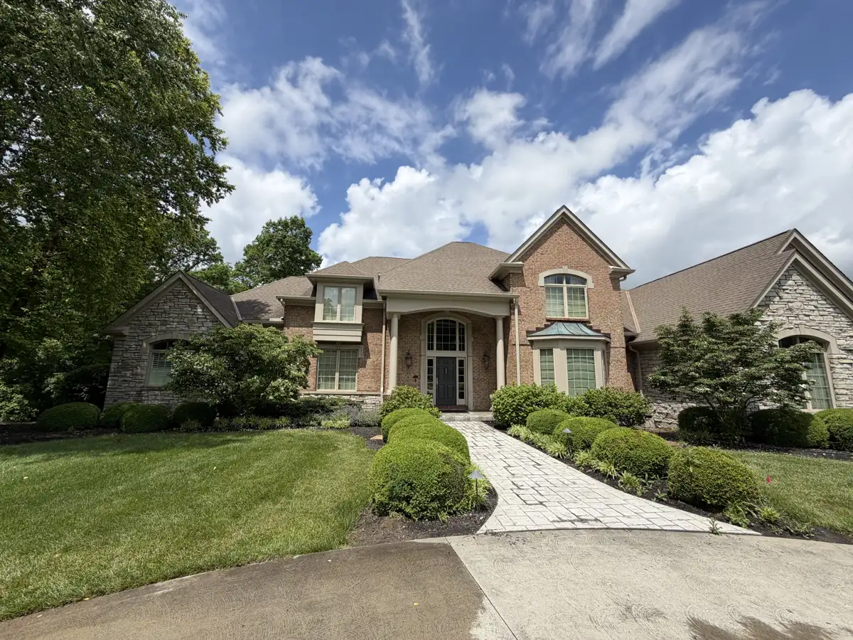 Brick & stone two-story home after exterior cleaning